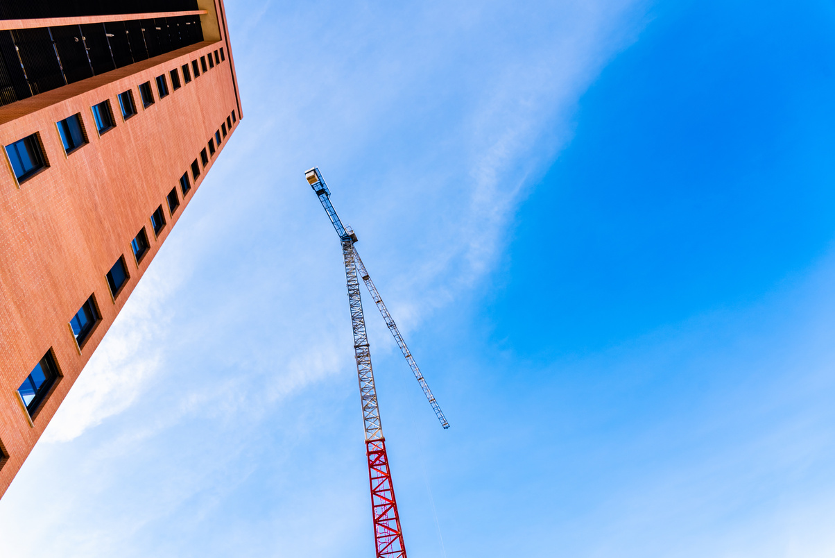 Residential Building Construction Companies Install Large Cranes